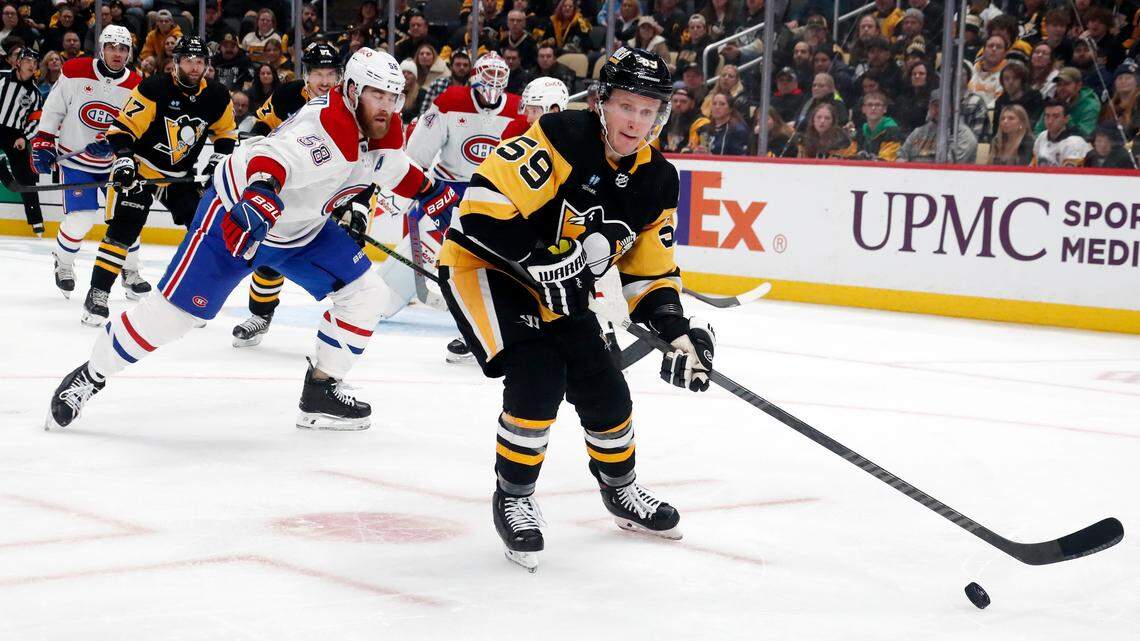 Pittsburgh Penguins left wing Jake Guentzel (59) handles the puck against the Montreal Canadiens during the third period at PPG Paints Arena. The Penguins won 3-2 in overtime.
