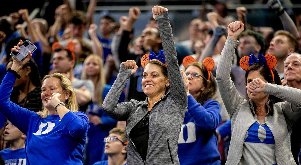 Debra Rosenbloum, center, celebrates with fellow Blue Devils fans during the closing minutes of play as Duke rolled to a 74-51 victory over Oral Roberts in the first round of the NCAA Tournament on Thursday, March 16, 2023 at the Amway Center in Orlando, Fla.