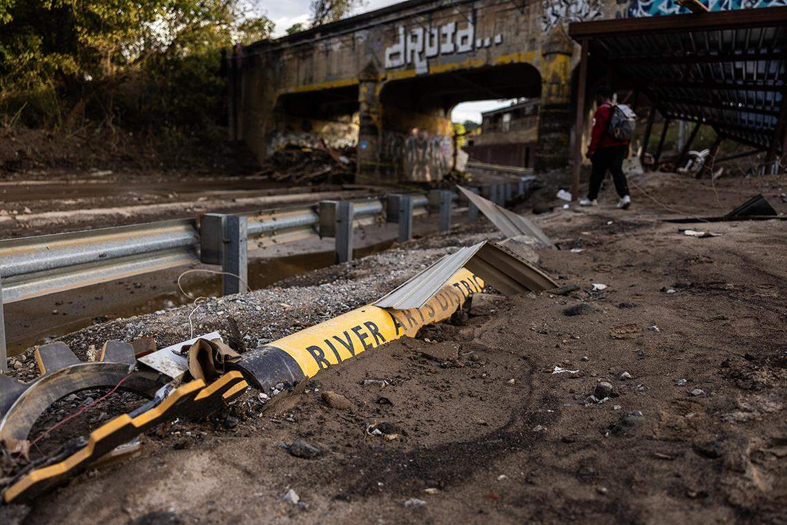 A sign for the River Arts District sits in the rubble on Riverside Drive in Asheville, N.C. on Tuesday, October 1, 2024.