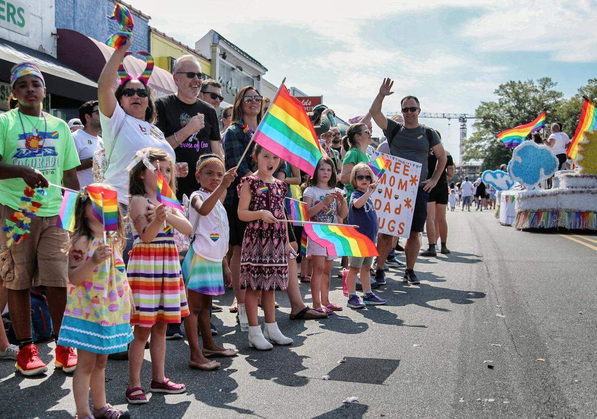 Parade-goers wave flags and cheer during the Durham Pride parade Saturday morning Sept. 28, 2019.