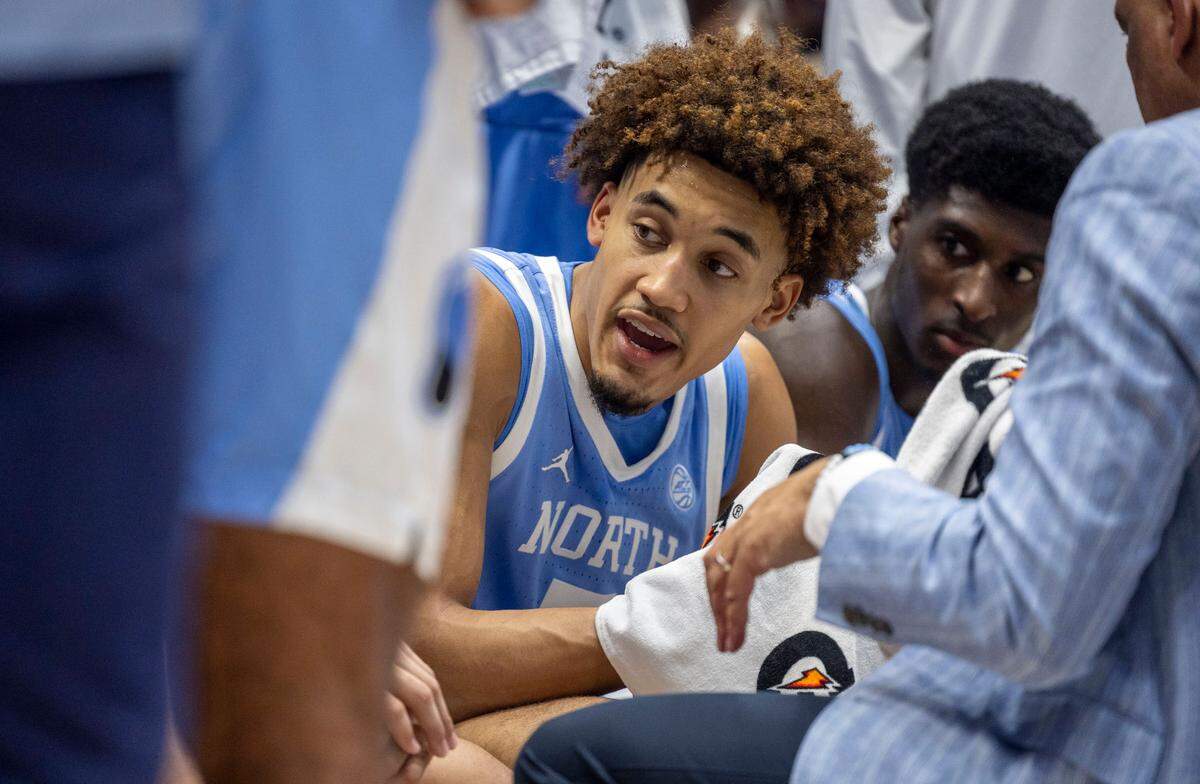 North Carolina guard Seth Trimble (7) talks with his teammates during a time-out huddle with coach Hubert Davis in the second half against Duke on Saturday, February 1, 2025 at Cameron Indoor Stadium in Durham, N.C.