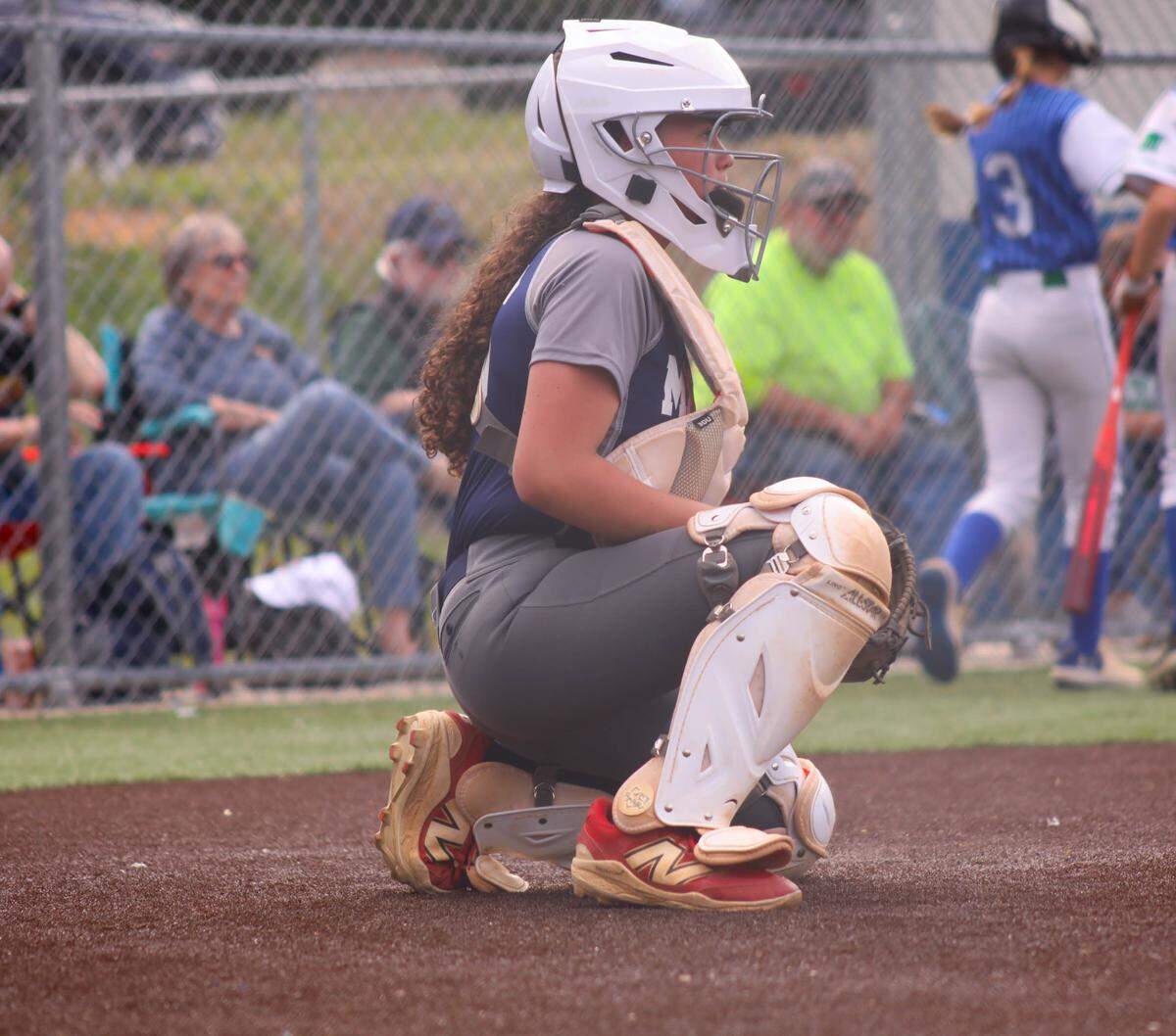 Madelyn Martin sits behind home plate during a Little League game. Martin will compete in the Maria Pepe Little League Baseball Legacy Series in Pennsylvania in June.
