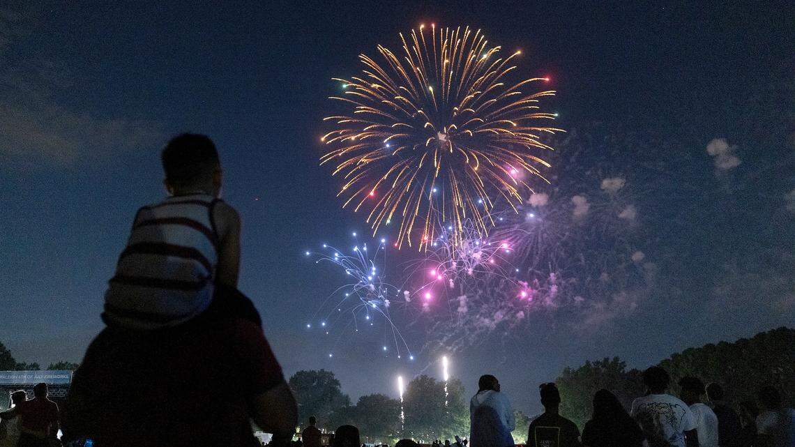 Crowds watch a fireworks display during an Independence Day celebration at Dorothea Dix Park in Raleigh on July 4, 2023.
