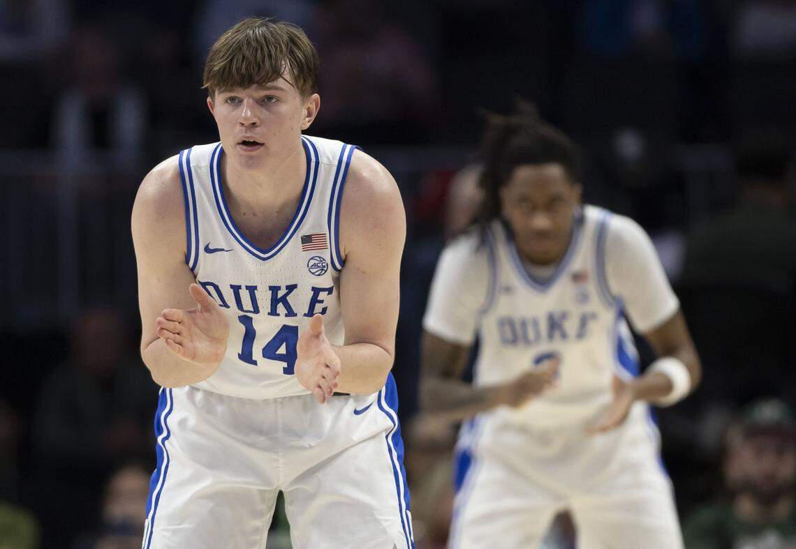 Duke guard Nikolas Khamenia (14) and forward Isaiah Evans (3) applaud a four point lead over Florida State in the first half on Thursday, March 12, 2026, during the quarterfinals of the ACC Tournament at Spectrum Center in Charlotte, N.C.