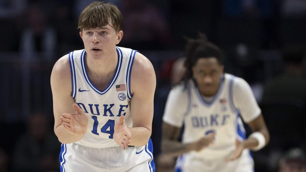 Duke guard Nikolas Khamenia (14) and forward Isaiah Evans (3) applaud a four point lead over Florida State in the first half on Thursday, March 12, 2026, during the quarterfinals of the ACC Tournament at Spectrum Center in Charlotte, N.C.