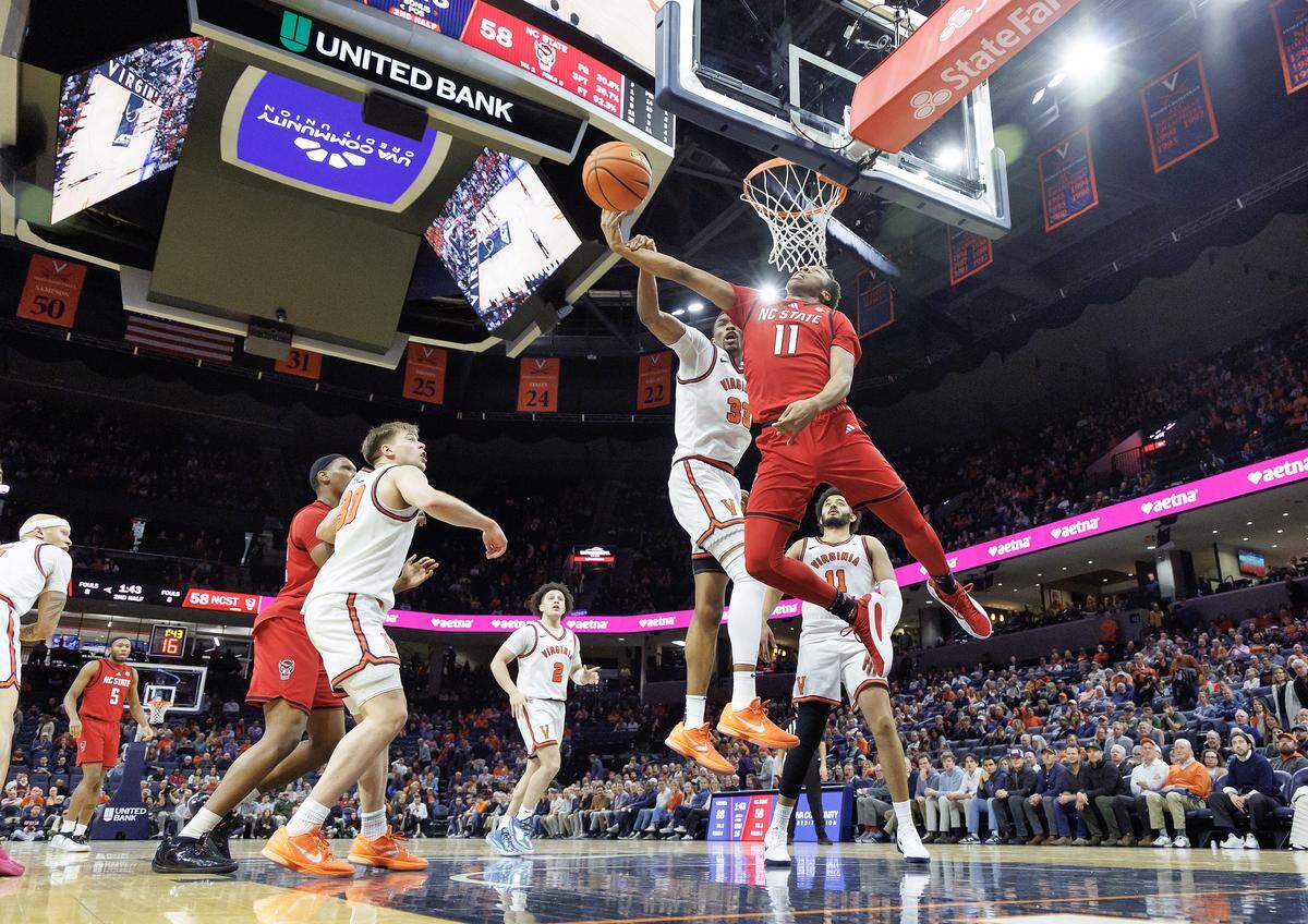 N.C. State's Quadir Copeland drives to the basket against Virginia's Ugonna Onyenso during the second half of the Wolfpack’s 90-61 loss on Thursday, Feb. 24, 2026, at John Paul Jones Arena in Charlottesville, Va. 