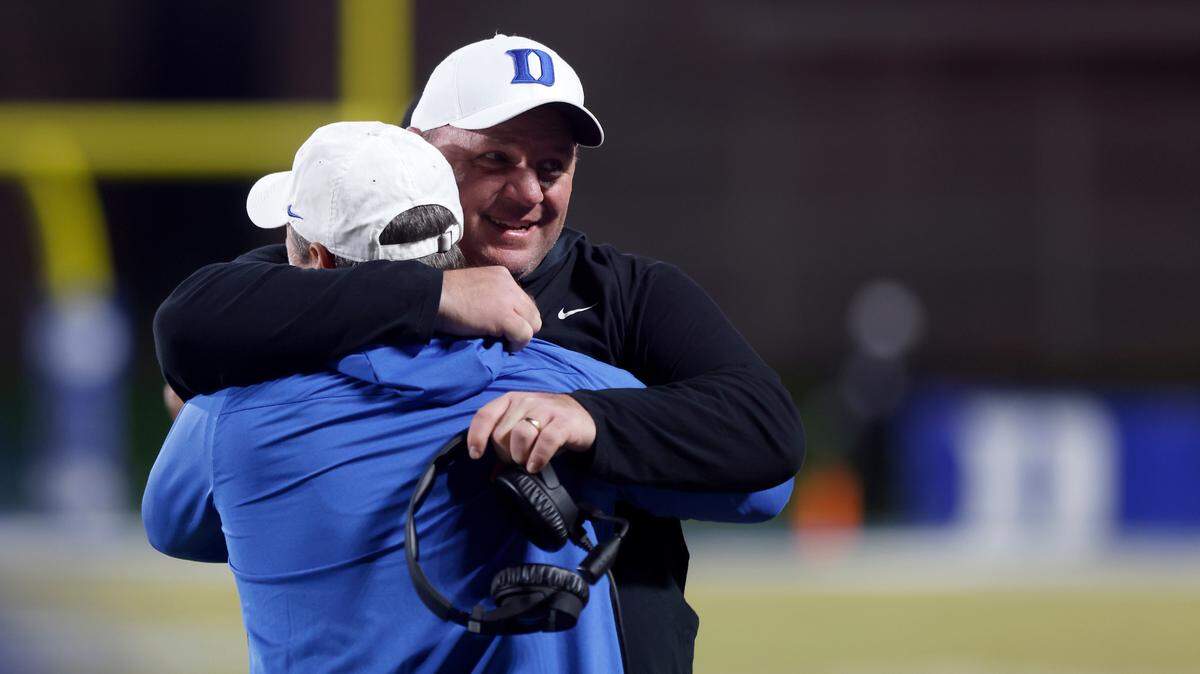 Duke head coach Mike Elko gets a hug on the sideline in the closing seconds of the Blue Devils’ 34-31 win over Wake Forest at Wallace Wade Stadium on Saturday, Nov. 26, 2022, in Durham, N.C.