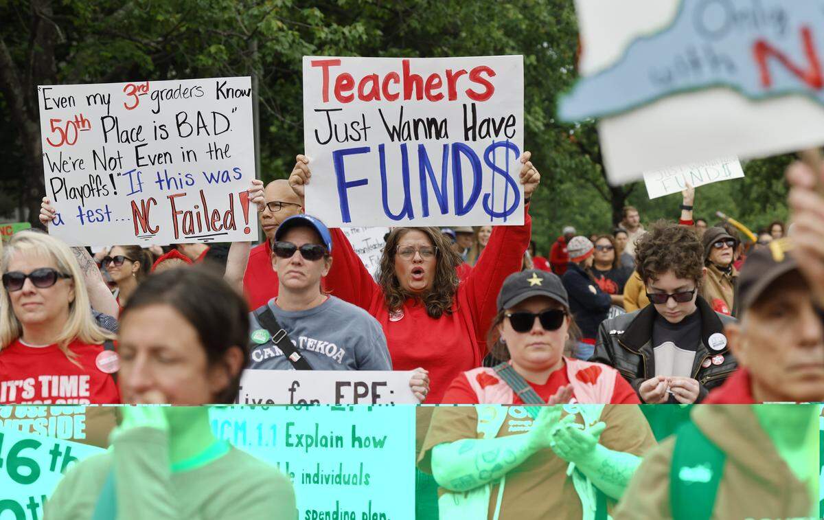 People cheer on the speakers during a rally to protest for more school funding at Halifax Mall in downtown Raleigh, N.C., Friday, May 1, 2026.  The North Carolina Association of Educators has mobilized teachers from across the state to march on the Legislative Building to demand higher pay, more school funding and higher taxes on corporations. 