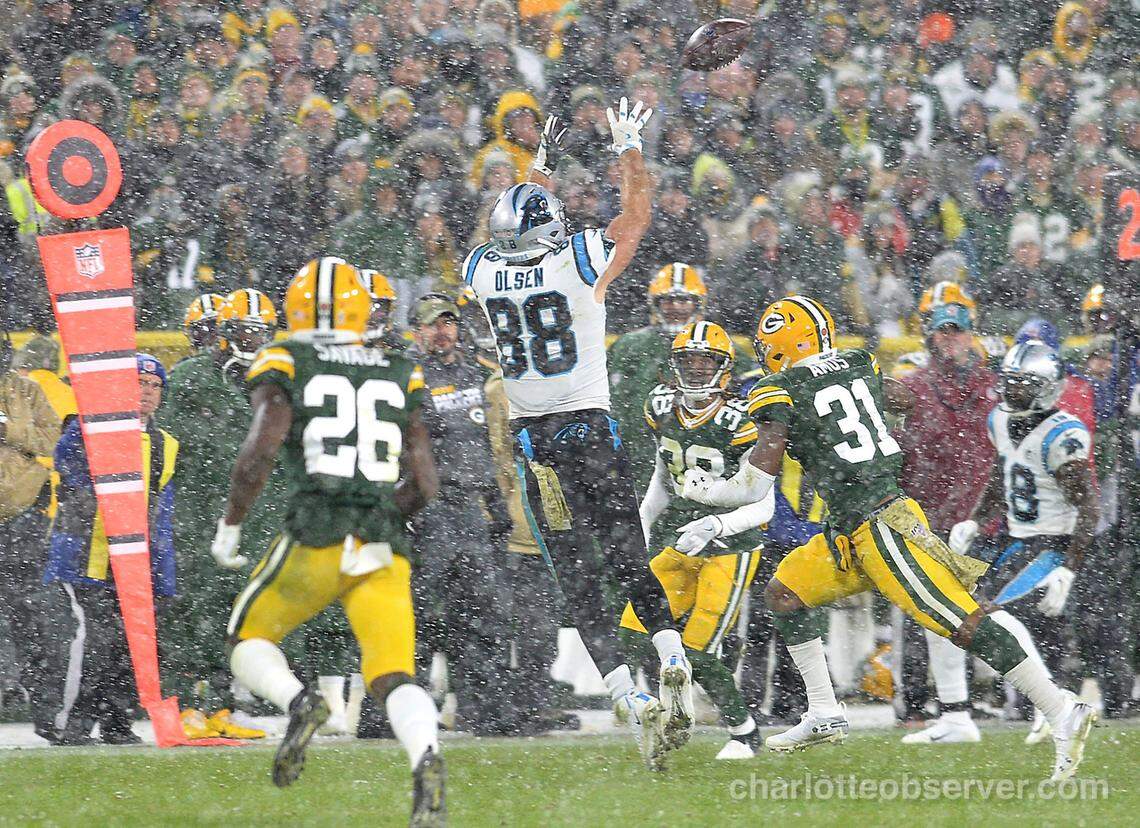 Carolina Panthers tight end Greg Olsen leaps to catch a pass from quarterback Kyle Allen in Green Bay in 2019, which was Olsen’s final season with the team.