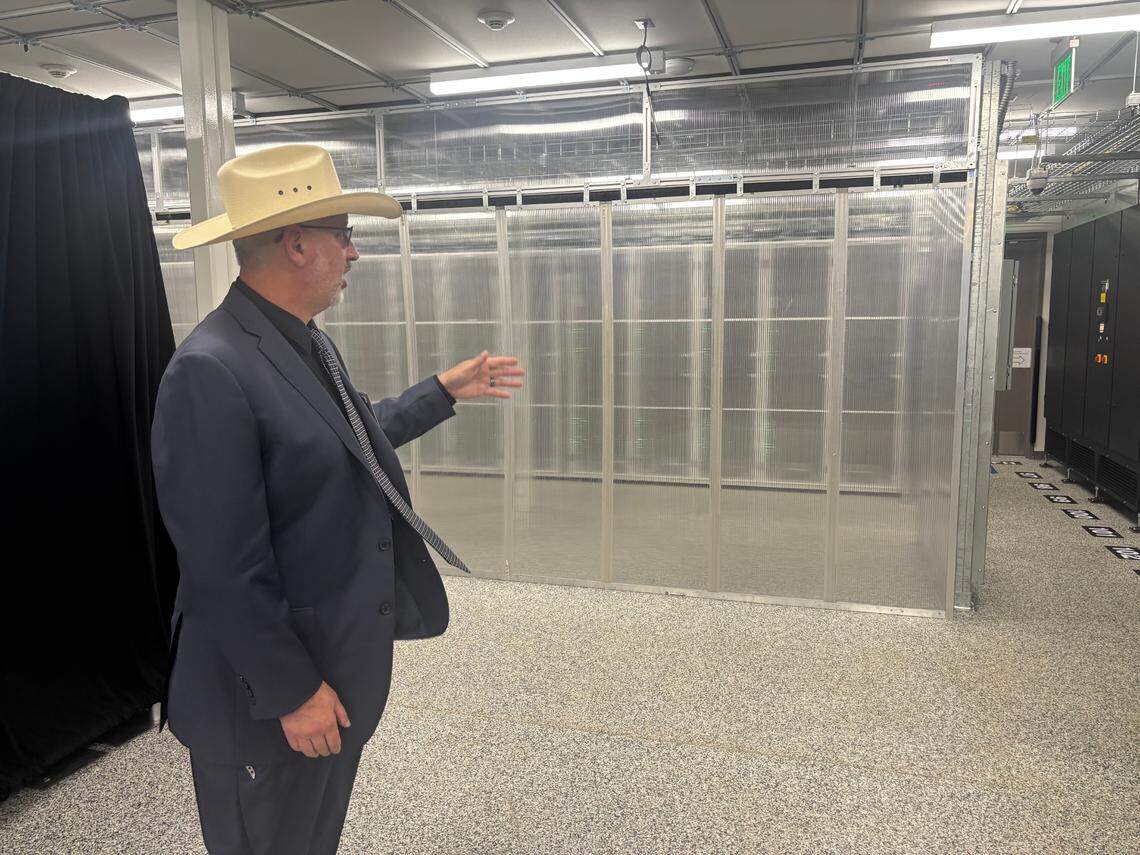 Michael Bailey, a North Carolina-based systems engineer at American Tower, points toward the cooling units within his company’s new edge data center in Raleigh, North Carolina.