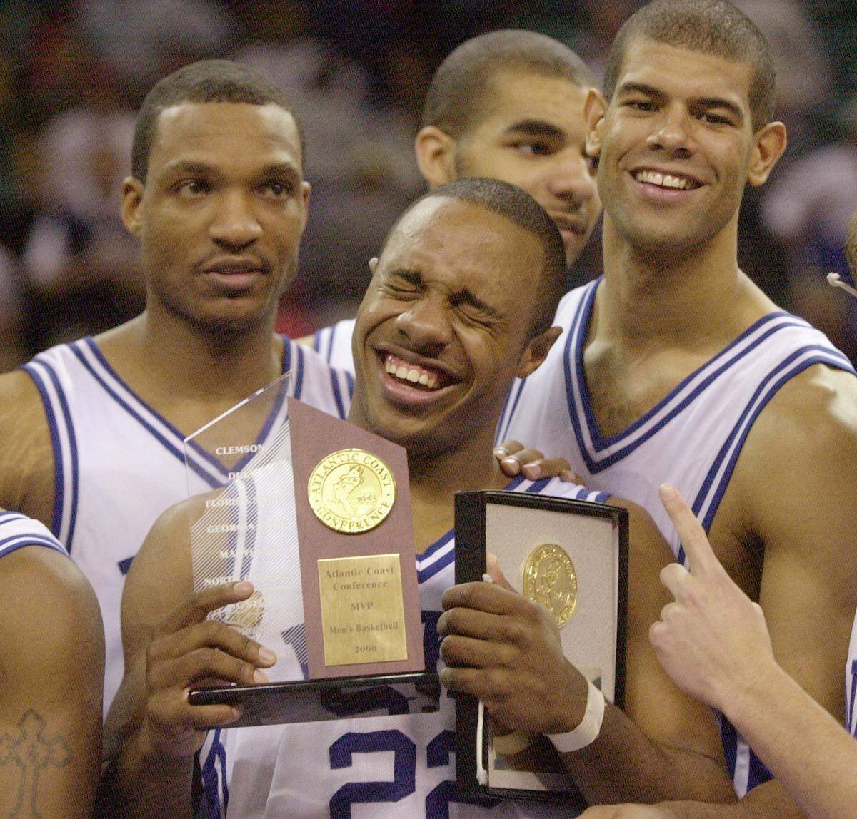 3/12/00 Duke tournament MVP Jason Williams holds his hardware and is surrounded by teammates, from left, Chris Carrawell, Carlos Boozer and Shane Battier after  Duke beat Maryland, 81-68, to win the ACC Title.