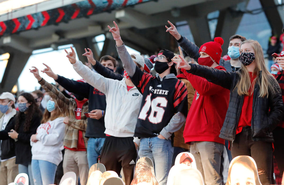 Fans cheer on the Wolfpack during the first half of N.C. State’s game against Georgia Tech at Carter-Finley Stadium in Raleigh, N.C., Saturday, Dec. 5, 2020.