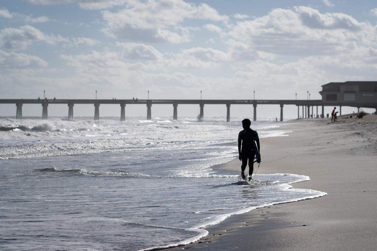 Sterling Stewart prepares to surf at Wrightsville Beach. He has participated in Surfers Healing, a camp teaching kids with autism how to surf. Since then, he has discovered his place: in the water on a surfboard. 