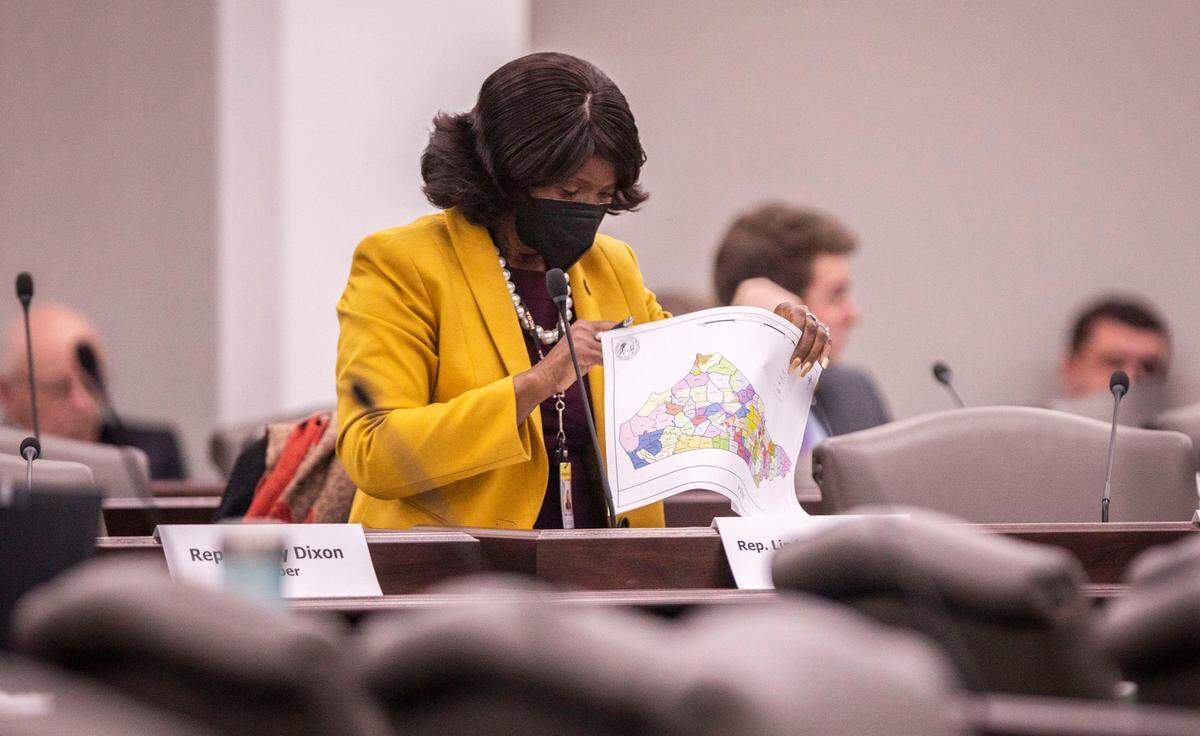 Rep. Linda Cooper-Suggs (D) looks over a packet on congressional maps before the start of a House Standing Committee meeting on redistricting at the Legislative Office Building in Raleigh, N.C. on Wednesday, Feb. 16, 2022. 