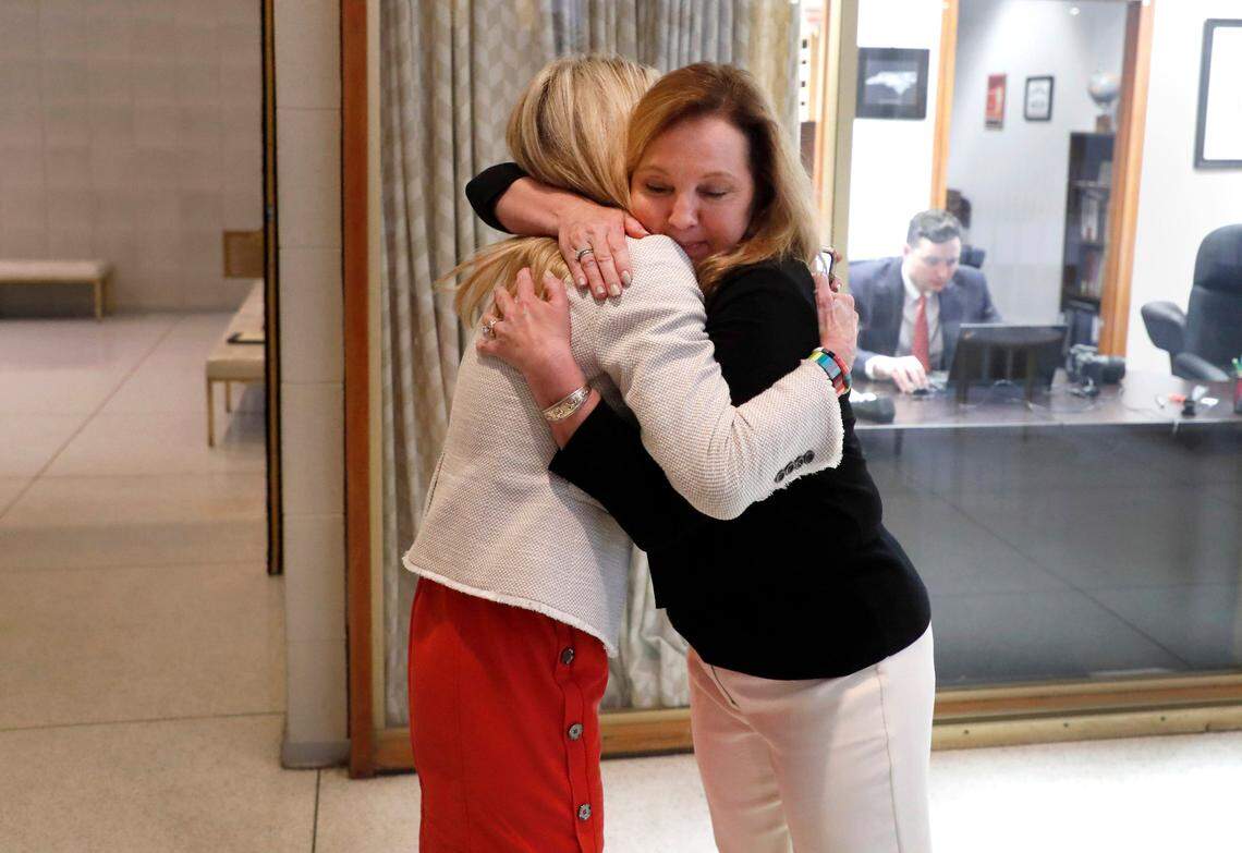 Judy Wiegand, right, hugs Rep. Kristin Baker after Wiegand spoke during a House Judiciary Committee meeting in Raleigh, N.C. Tuesday, June 22, 2021. Wiegand, who was married when she was 13, was speaking in favor of Senate Bill 35, which would raise the minimum age to be married to 16.
