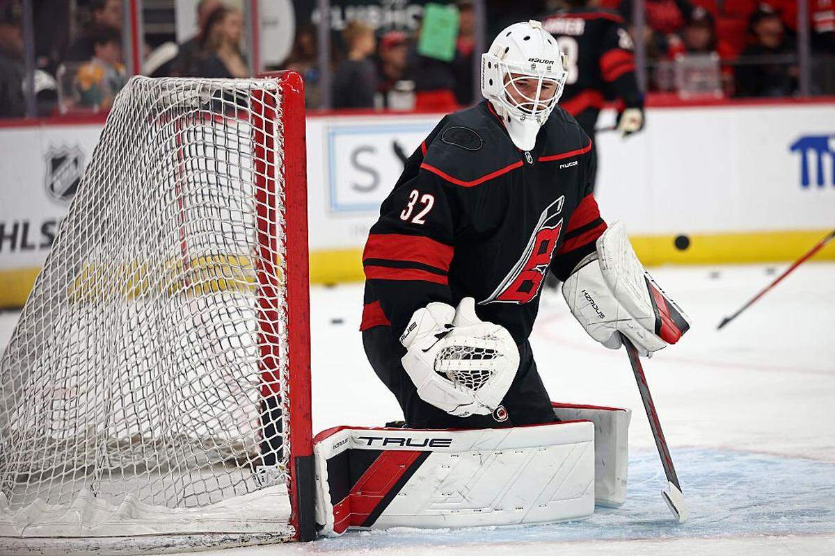Brandon Bussi of the Carolina Hurricanes warms up prior to the game against the New Jersey Devils at Lenovo Center on October 09, 2025 in Raleigh, North Carolina.