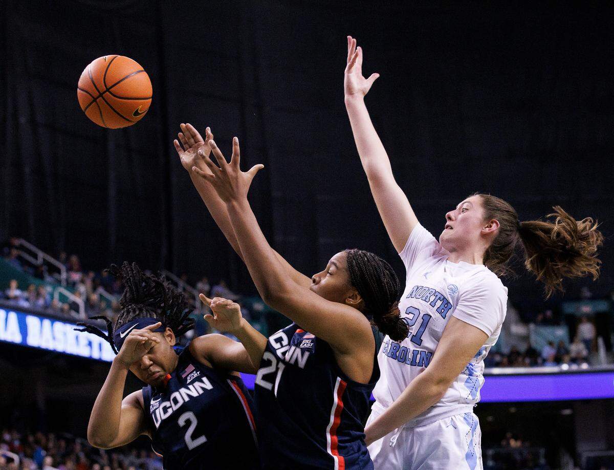 North Carolina’s Ciera Toomey battles for a rebound with UConn’s KK Arnold and Sarah Strong during the second half of the Tar Heels’ 69-58 loss on Friday, Nov. 15, 2024, at First Horizon Coliseum in Greensboro, N.C.