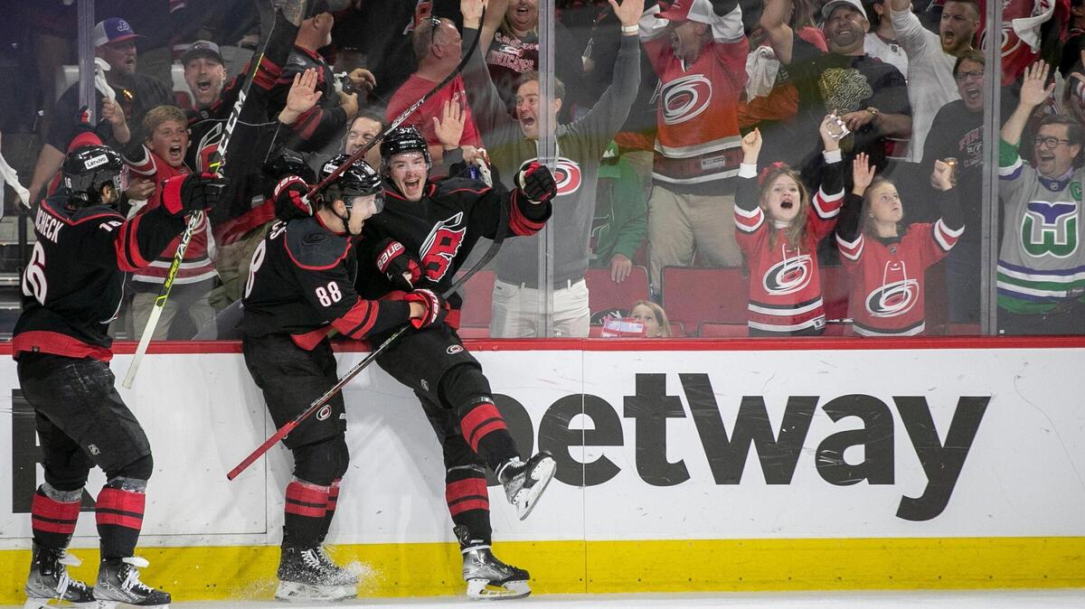 Carolina Hurricanes’ Andrei Svechnikov (37) celebrates with teammates Vincent Trocheck (16) and Martin Necas (88) after scoring to secure a 3-1 victory over the New York Rangers on Thursday, May 26, 2022 during game five of the Stanley Cup second round at PNC Arena in Raleigh, N.C.