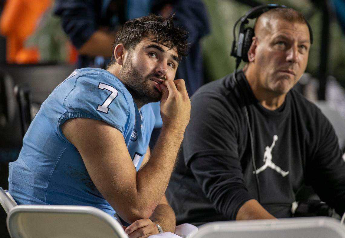 North Carolina quarterback Sam Howell (7) and offensive coordinator Phil Longo watch the final minute of play as Florida State runs out the clock to secure their 35-25 victory on Saturday, October 9, 2021at Kenan Stadium in Chapel Hill, N.C.