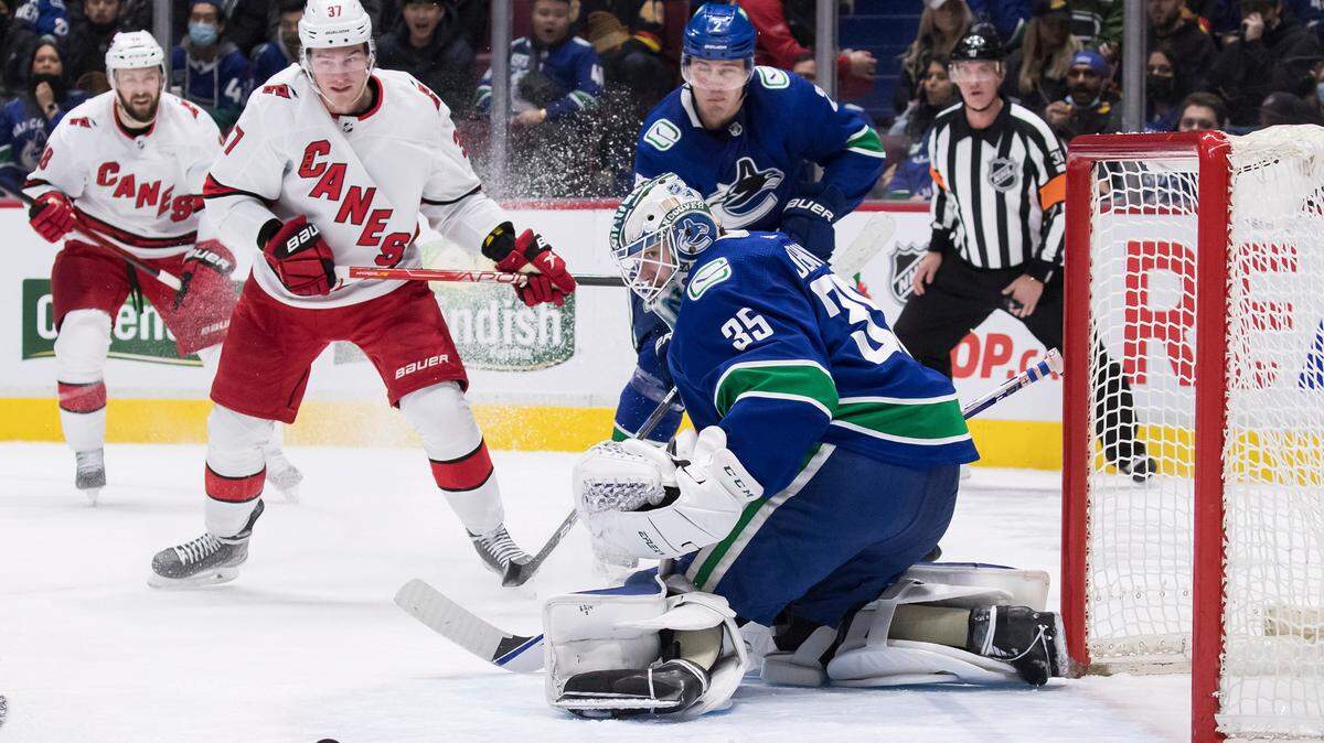 Vancouver Canucks goalie Thatcher Demko (35) stops Carolina Hurricanes’ Andrei Svechnikov (37), of Russia, during the first period of an NHL hockey game Sunday, Dec. 12, 2021 in Vancouver, British Columbia. (Darryl Dyck/The Canadian Press via AP)