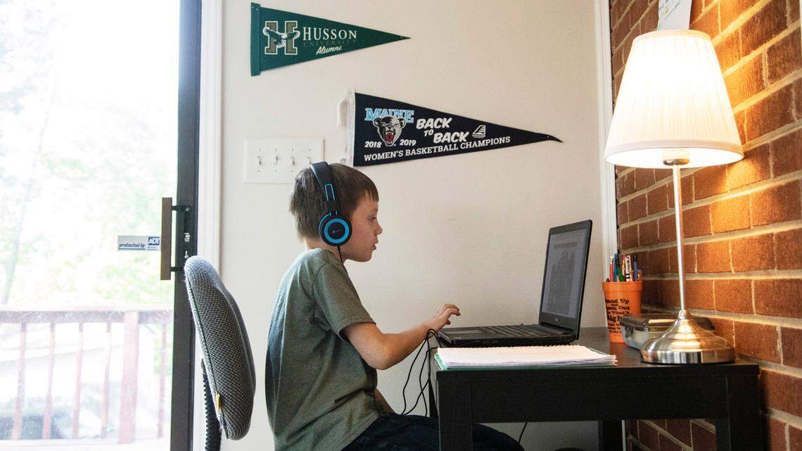 Eli Spencer, a second-grader at Powell Center for Play and Ingenuity Magnet Elementary uses a laptop to participate in a remote learning assignment at his home in Raleigh, NC, on March 17, 2020. Students, parents and teachers adjusted to remote learning when the coronavirus pandemic closed schools.