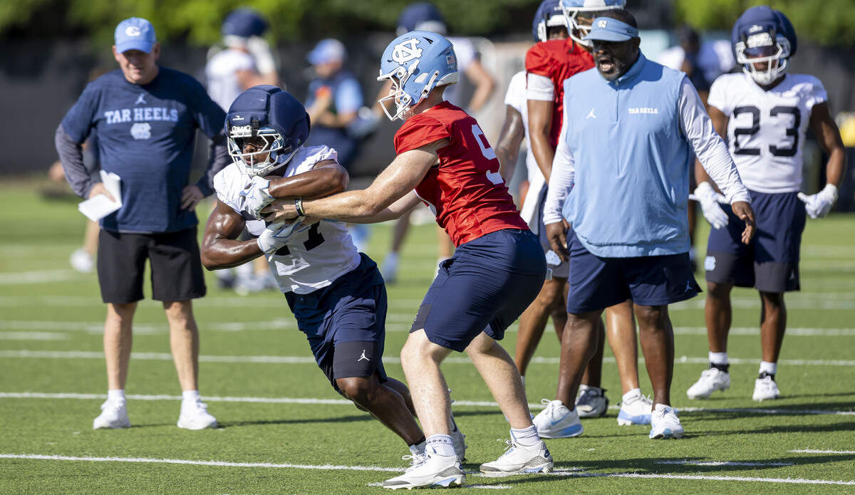 North Carolina quarterback Billy Edwards (8) hands off to running back Jaylen McGill (27) during the Tar Heels’ practice on Thursday, July 30, 2026 in Chapel Hill, N.C.