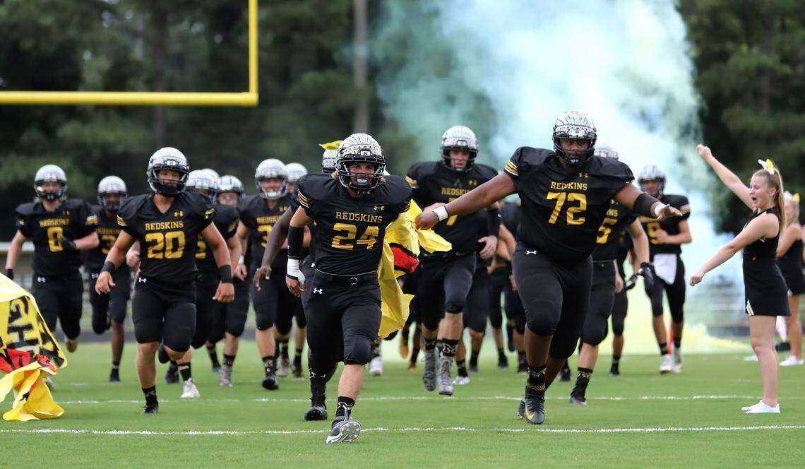 The Manteo High School varsity football team takes the field before a game against Currituck County High School in Manteo, N.C. in August 2019.