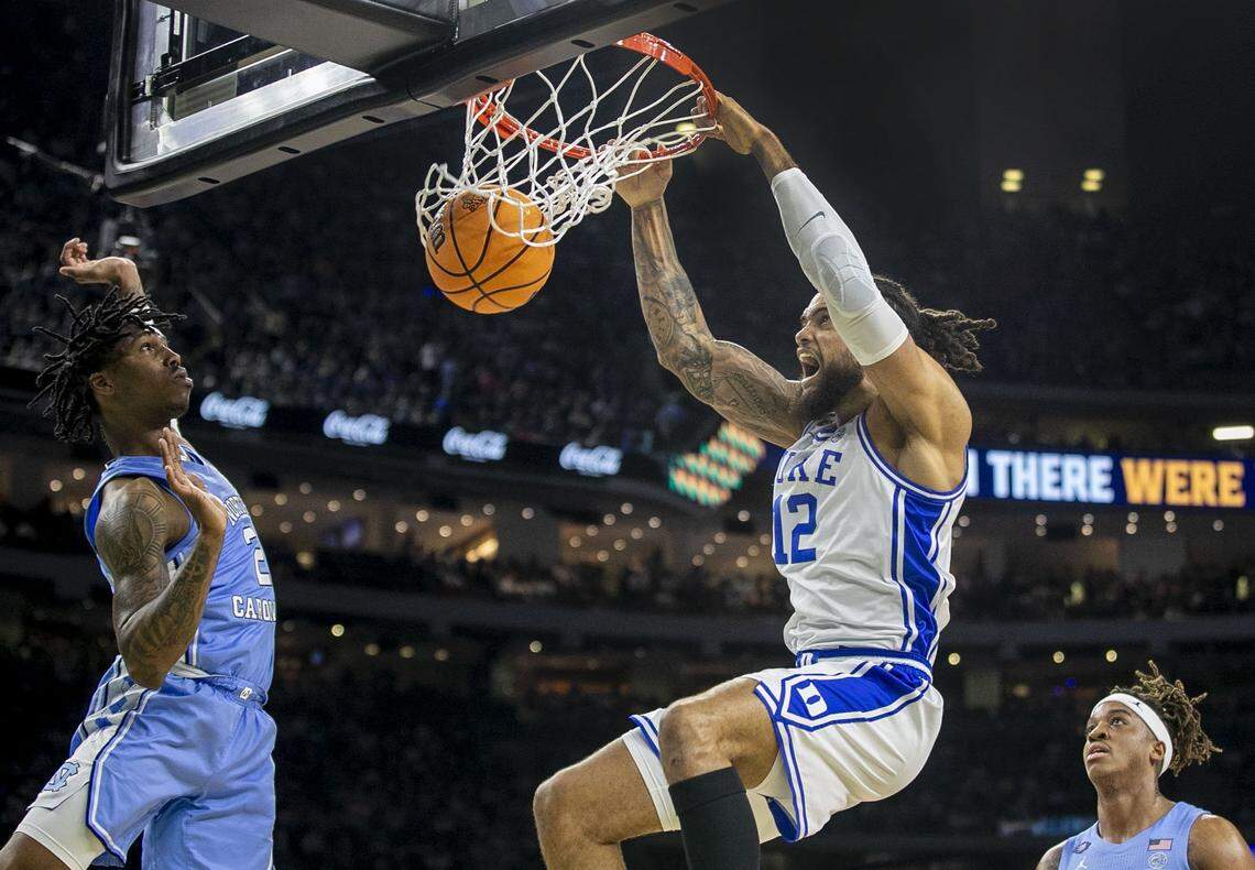 Dukes Theo John (12) dunks over North Carolinas Caleb Love (2) in the first half during the NCAA Final Four semi-final on Saturday, April 2, 2022 at Caesars Superdome in New Orleans, La.