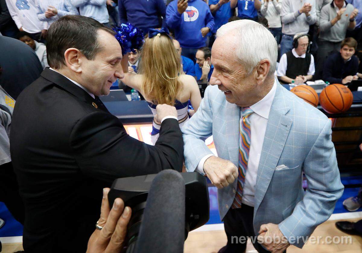 Duke head coach Mike Krzyzewski and UNC head coach Roy Williams bump arms as they greet each other before the North Carolina Tar Heels’ game against the Duke Blue Devils at Cameron Indoor Stadium in Durham, N.C., Saturday, March 7, 2020.