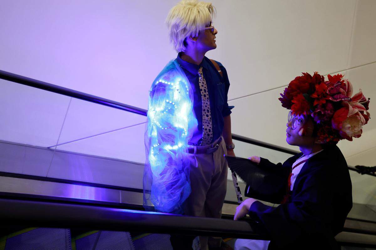 Attendees at GalaxyCon Raleigh take the escalator at the Raleigh Convention Center Saturday evening July 27, 2024.