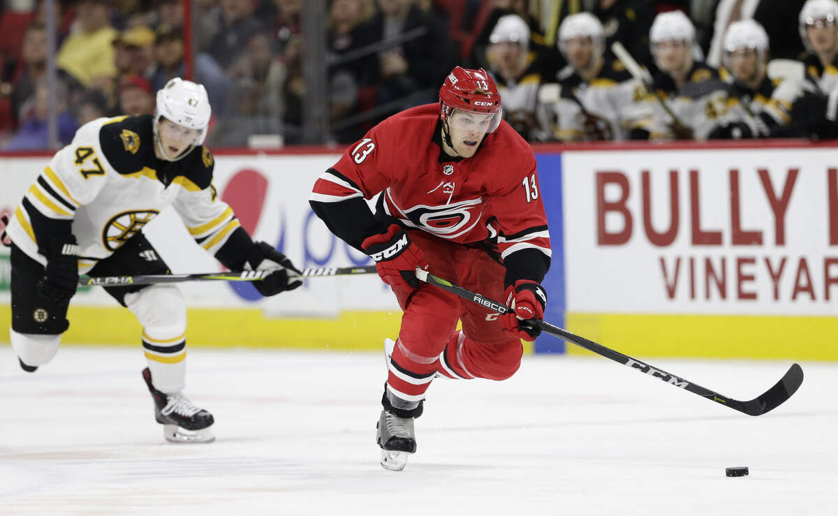 Carolina Hurricanes’ Warren Foegele (13) skates against Boston Bruins’ Torey Krug (47) during the second period of an NHL hockey game in Raleigh, N.C., Tuesday, Oct. 30, 2018.