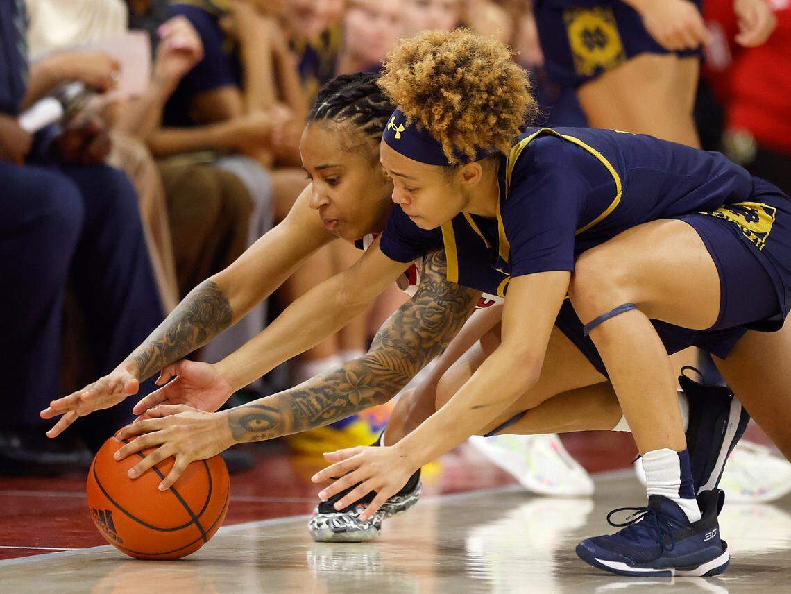 N.C. State’s Aziaha James and Notre Dame’s Hannah Hidalgo lunge after a loose ball during the second half of the Wolfpack’s 104-95 double overtime win on Sunday, Feb. 23, 2025, at Reynolds Coliseum in Raleigh, N.C.