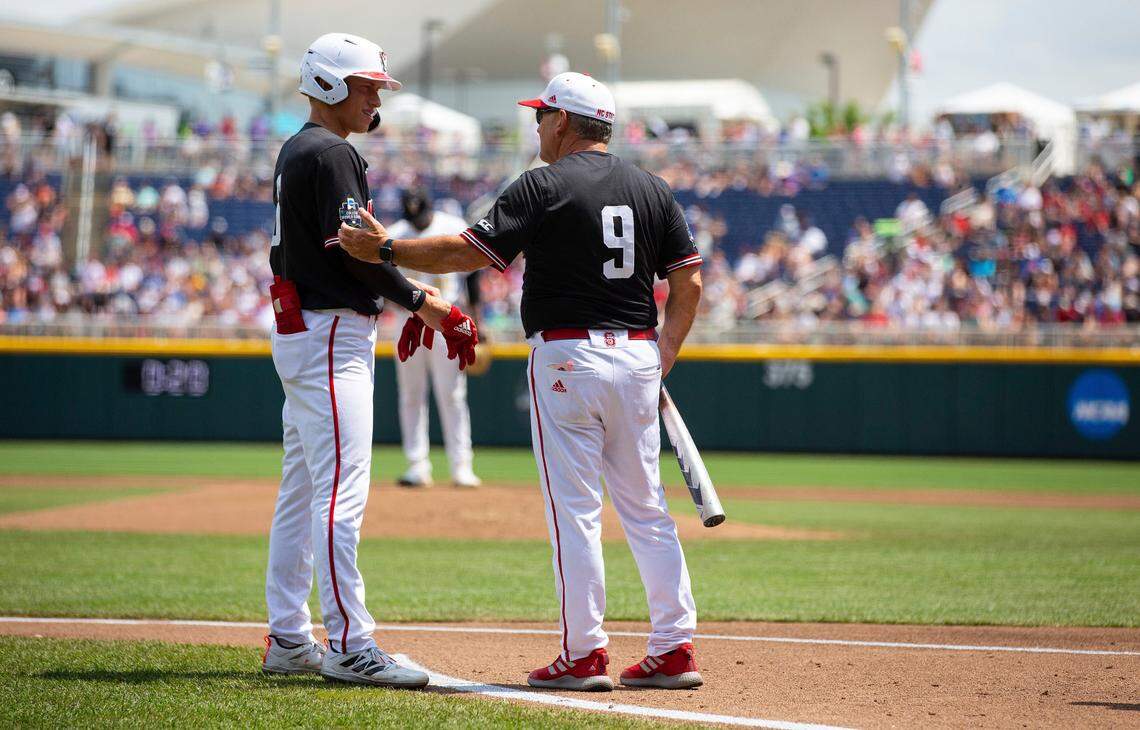 North Carolina State head coach Elliott Avent, right, talks with Vojtech Mensik before Mensik goes to bat again after his hit was called back as a foul ball after further review in the second inning against Vanderbilt during a baseball game in the College World Series, Friday, June 25, 2021, at TD Ameritrade Park in Omaha.