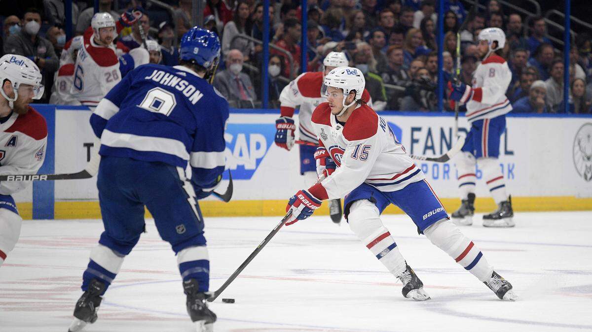 Montreal Canadiens center Jesperi Kotkaniemi (15) controls a puck in front of Tampa Bay Lightning center Tyler Johnson (9) during the first period of Game 2 of the NHL hockey Stanley Cup finals series, Wednesday, June 30, 2021, in Tampa, Fla. (AP Photo/Phelan M. Ebenhack)