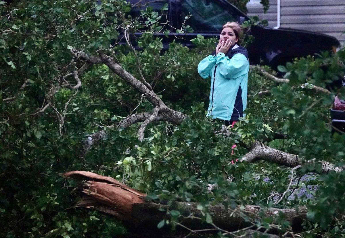 Zuram Rodriguez surveys the damage around her mobile home in Davie, Fla., early Wednesday, Sept. 28, 2022. Hurricane Ian rapidly intensified off Florida’s southwest coast Wednesday morning, gaining top winds of 155 mph (250 kph), just shy of the most dangerous Category 5 status. (Joe Cavaretta/South Florida Sun-Sentinel via AP)