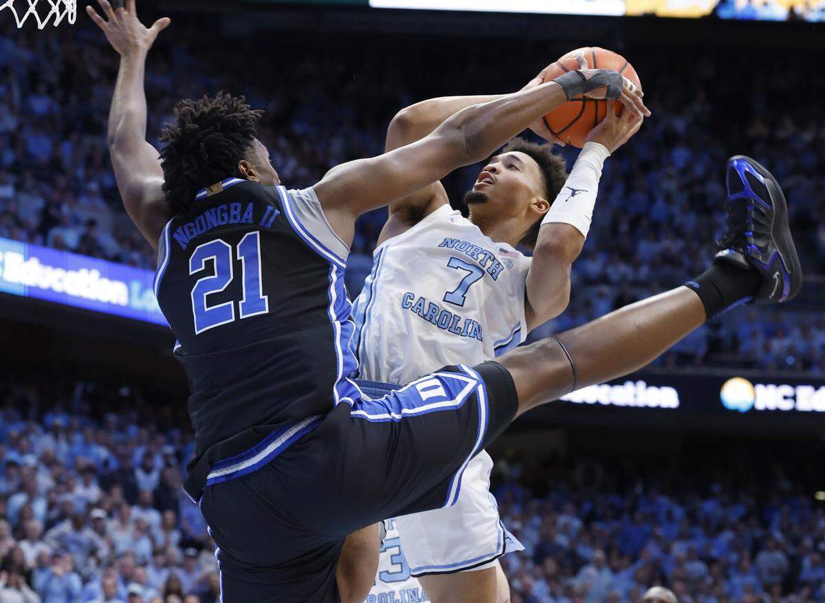 Duke’s Patrick Ngongba II (21) fouls North Carolina's Seth Trimble (7) during the first half of Duke’s game against UNC at the Dean E. Smith Center in Chapel Hill, N.C., Saturday, Feb. 7, 2026.