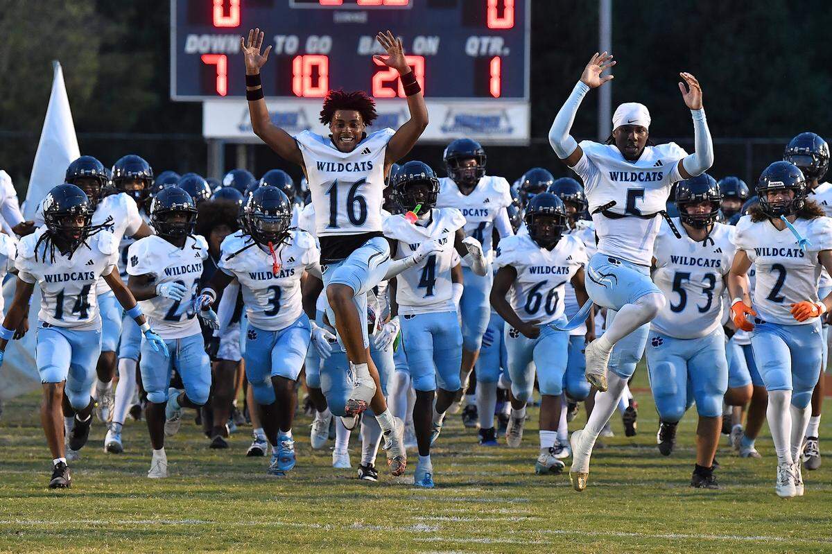 The Millbrook Wildcats rush onto the field before their game  against Rolesville. The Millbrook Wildcats and the Rolesville Rams met in a conference football game in Rolesville, N.C. September 26, 2025