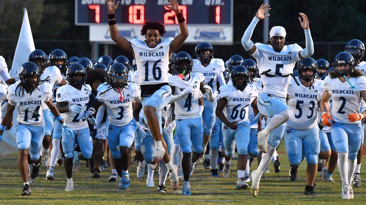 The Millbrook Wildcats rush onto the field before their game  against Rolesville. The Millbrook Wildcats and the Rolesville Rams met in a conference football game in Rolesville, N.C. September 26, 2025