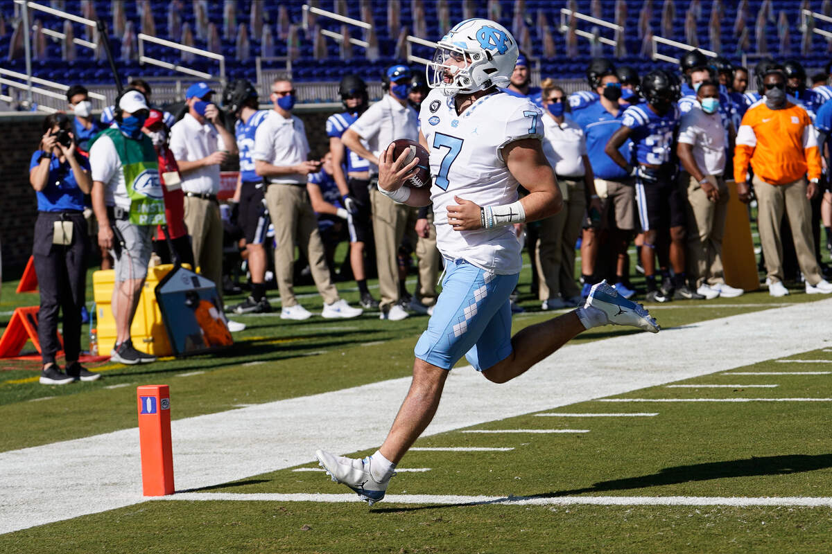 North Carolina Tar Heels quarterback Sam Howell (7) scores a touchdown against the Duke Blue Devils during the first quarter at Wallace Wade Stadium. 