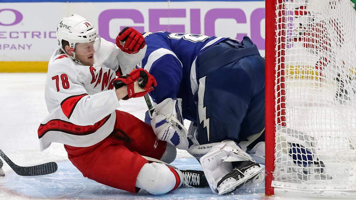 Carolina Hurricanes’ Steven Lorentz (78) crashes into Tampa Bay Lightning goaltender Andrei Vasilevskiy during the first period of an NHL hockey game Tuesday, April 20, 2021, in Tampa, Fla. (AP Photo/Mike Carlson)