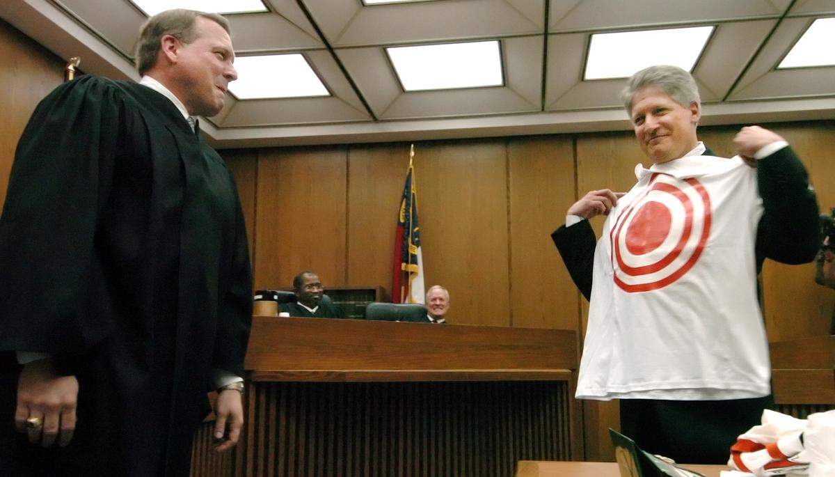 Newly appointed Judge Jim Hardin (left) watches as his newly appointed replacement Mike Nifong models a t-shirt Hardin gave him after his swearing in ceremony as the new Durham District Attorney April 27, 2005 at the Durham County Judicial Building.