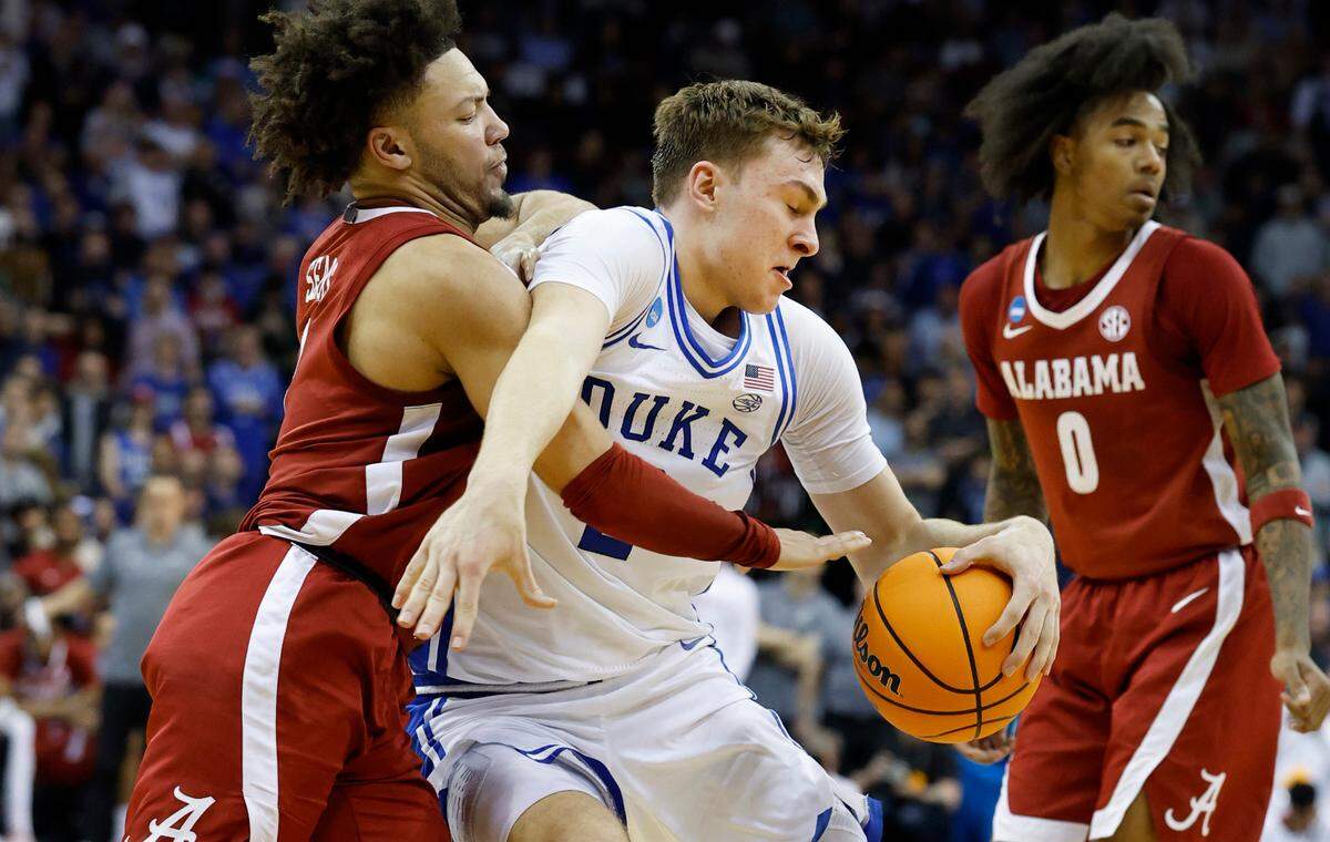 Duke’s Cooper Flagg (2) gets by Alabama’s Mark Sears (1) during the second half of Duke’s 85-65 victory over Alabama in their Elite 8 game in the 2025 NCAA Men’s Basketball Championship at the Prudential Center in Newark, N.J., Saturday, March 29, 2025.