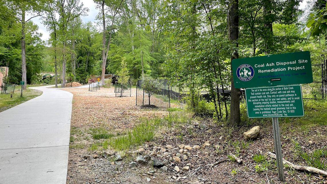 A sign posted along the Bolin Creek Greenway in Chapel Hill explains the town’s efforts to monitor and contain coal ash deposits located under the Chapel Hill Police Department site at 828 Martin Luther King Jr. Blvd.