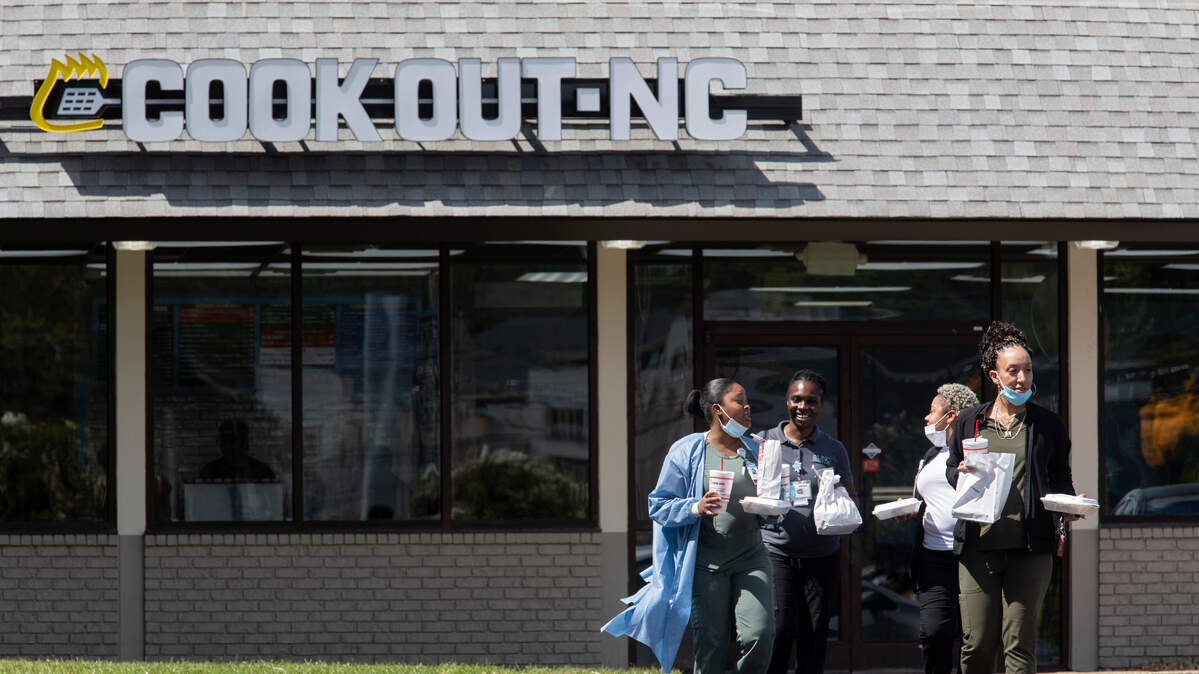 From left, Fiona Mclean, Jolene Warner, Destiny Crisp and LaKenna Saunders walk out of a new Cook Out on Elliot Road in Chapel Hill, N.C. on Monday, Sept. 12, 2022.