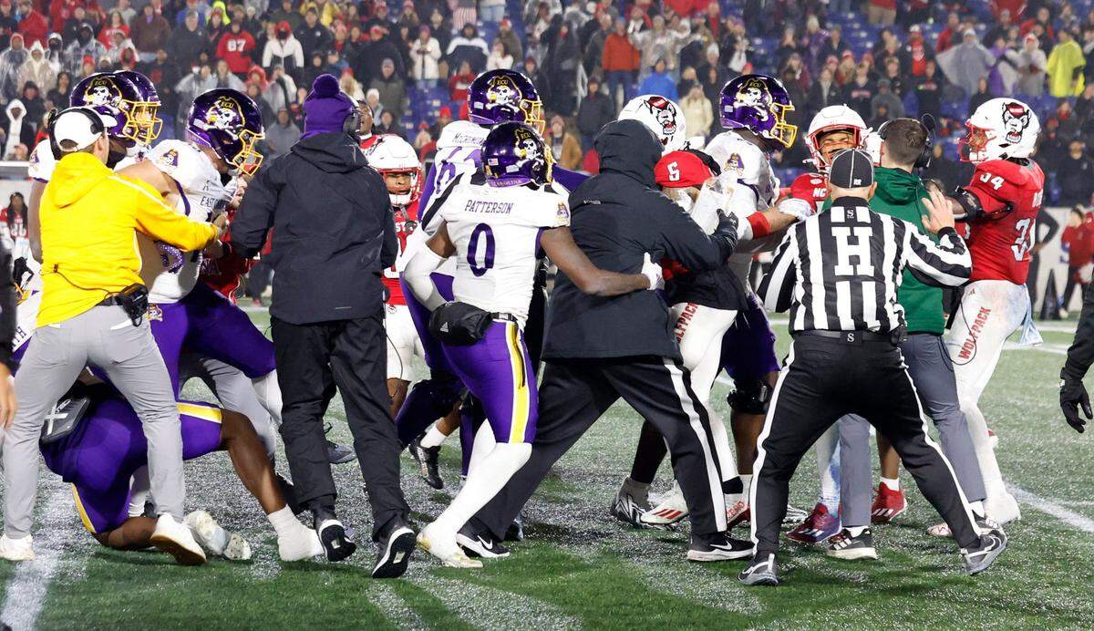 East Carolina and N.C. State players fight late in the second half of ECU's 26-21 victory over N.C. State in the Military Bowl at Navy-Marine Corps Memorial Stadium in Annapolis, Md., Saturday, Dec. 28, 2024.
