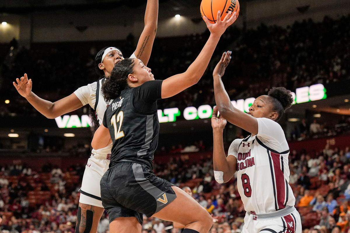 Vanderbilt Commodores forward Khamil Pierre (12) drives to the basket against South Carolina Gamecocks forward Joyce Edwards (8) at Bon Secours Wellness Arena.
