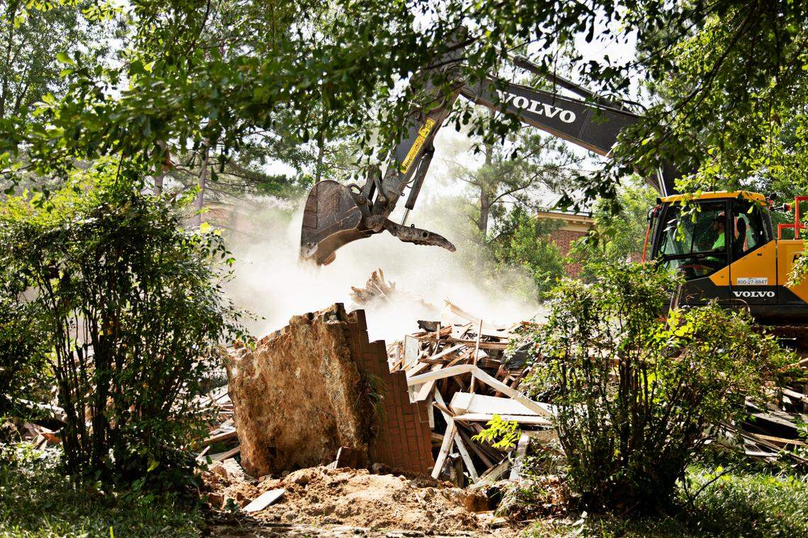 The remnants of three homes on White Oak Road in Raleigh are removed to make way for a parking lot behind Hayes Barton Baptist Church in Raleigh on Tuesday morning, June 7, 2022.