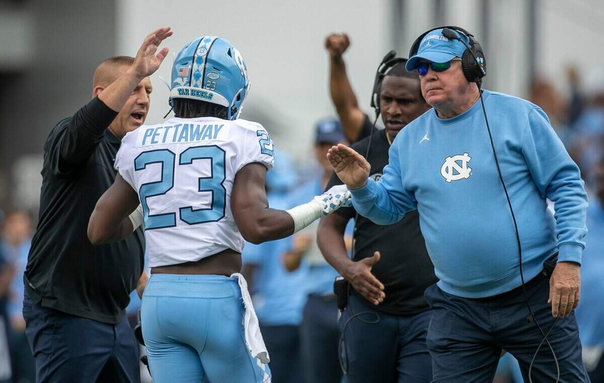 North Carolina head coach Mack Brown and offensive coordinator Phil Longo greet George Pettaway (23) after a 21-yard touchdown run in the second quarter against Appalachian State on Saturday, September 3, 2022 at Kidd Brewer Stadium in Boone, N.C.