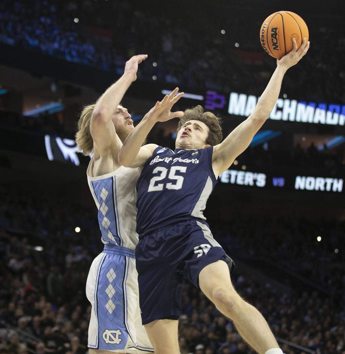 North Carolina’s Brady Manek (45) defends Saint Peters Doug Edert (25) in the first half during the NCAA East Regional final on Sunday, March 27, 2022 at Wells Fargo Center in Philadelphia, Pa.