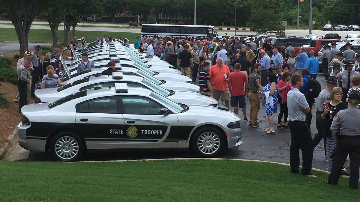 Twenty newly sworn State Highway Patrol troopers emerged from the basic training graduation ceremony to find 20 new Dodge Charger patrol cars on Saturday, May 26, at Colonial Baptist Church in Cary.